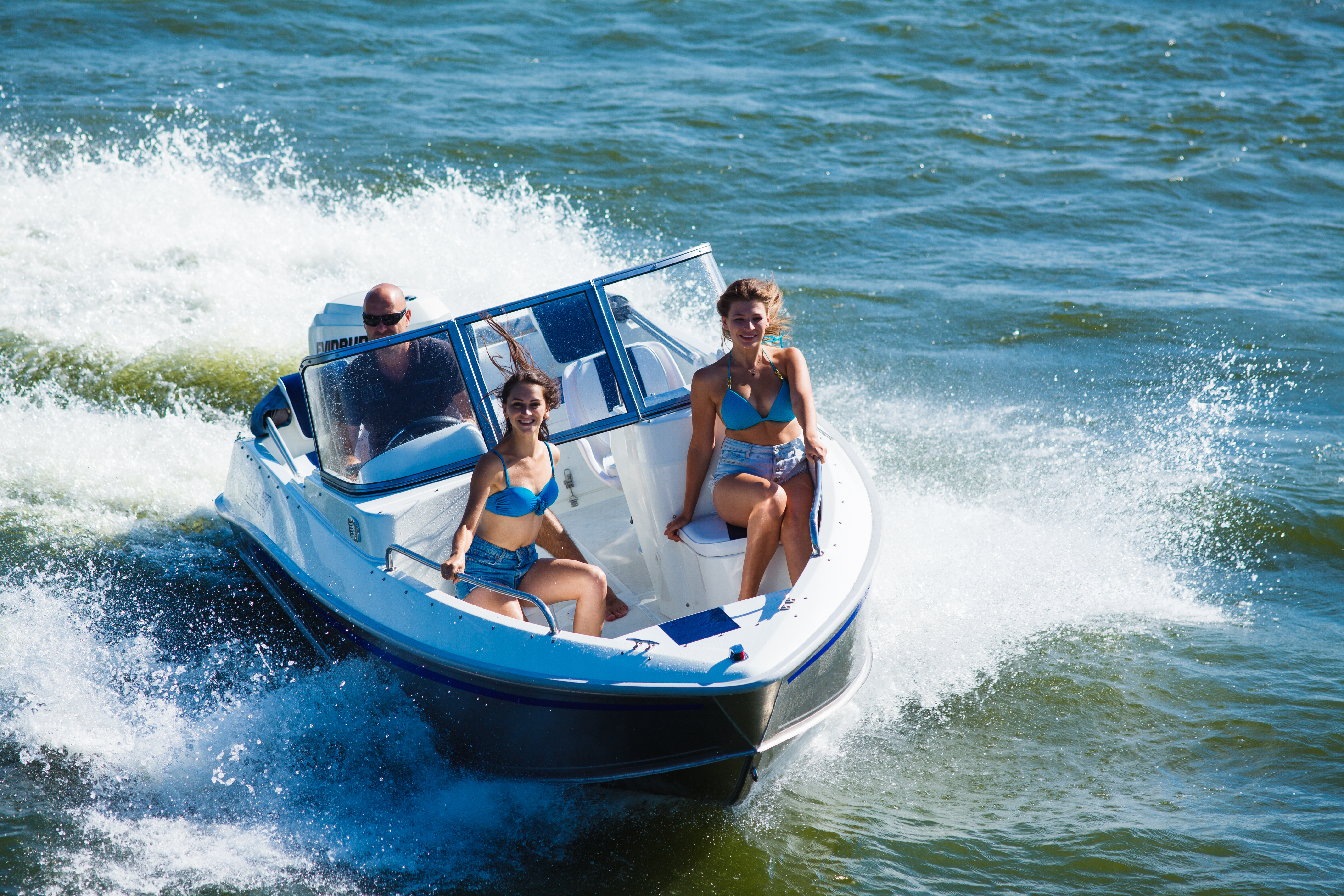 people riding in a speed boat